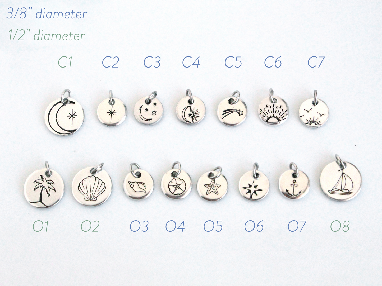 Set of silver charms with various designs on a white background