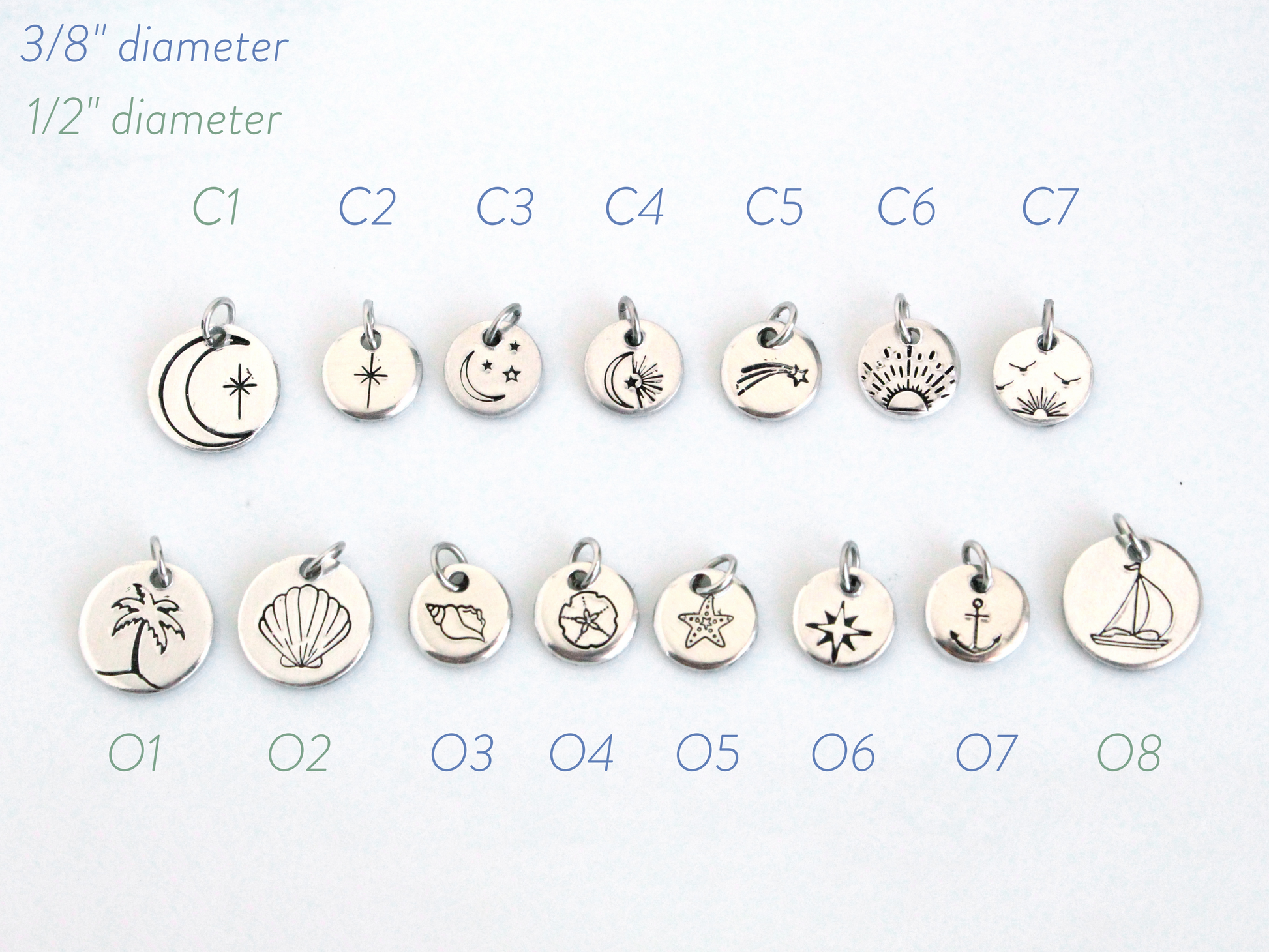 Set of silver charms with various designs on a white background