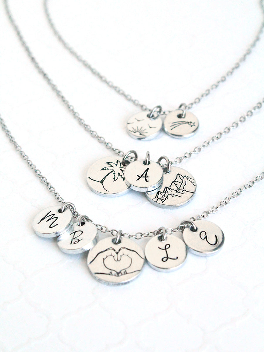 Silver necklaces with various pendants on a white background