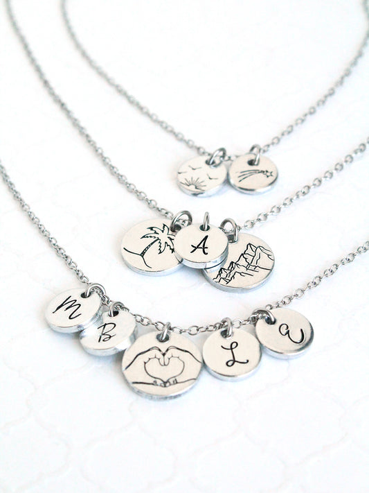 Silver necklaces with various pendants on a white background