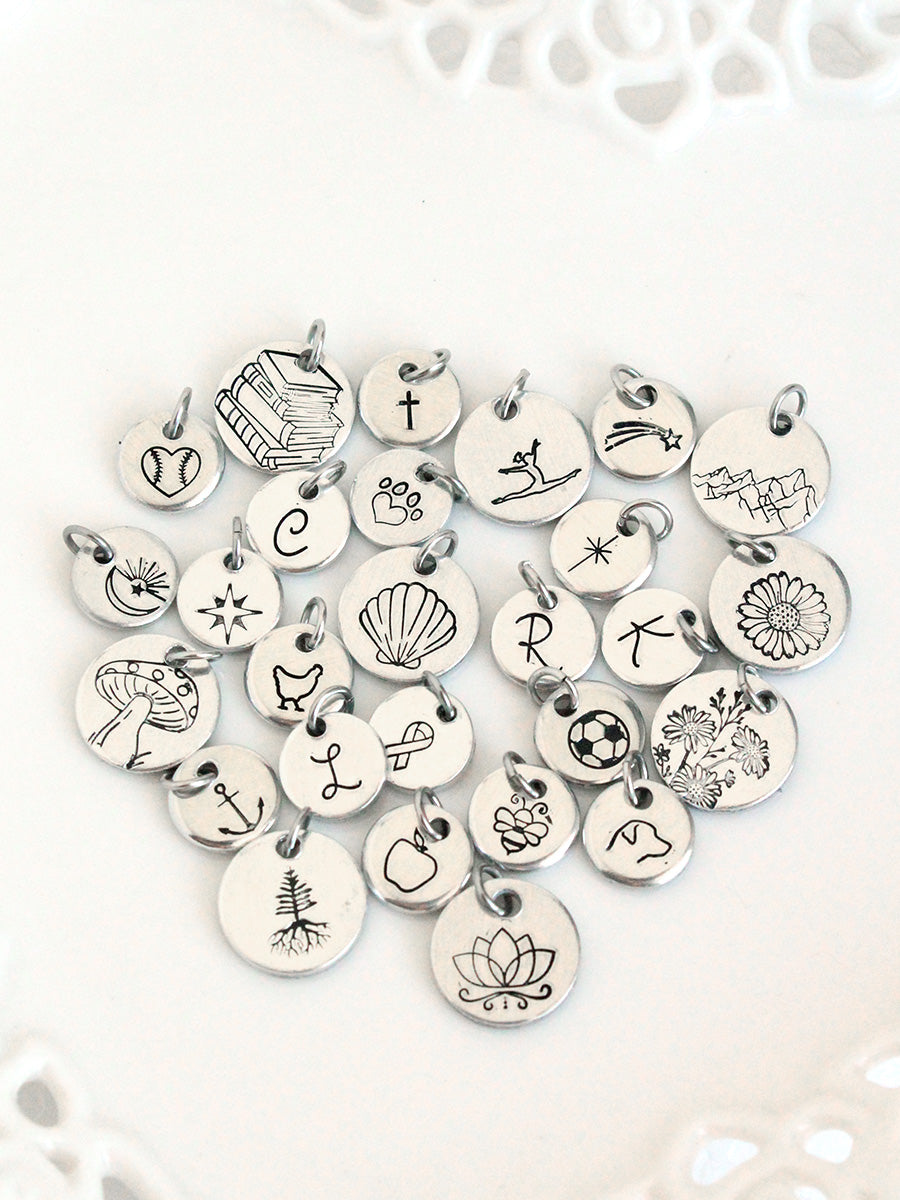 Collection of various silver charms on a white background