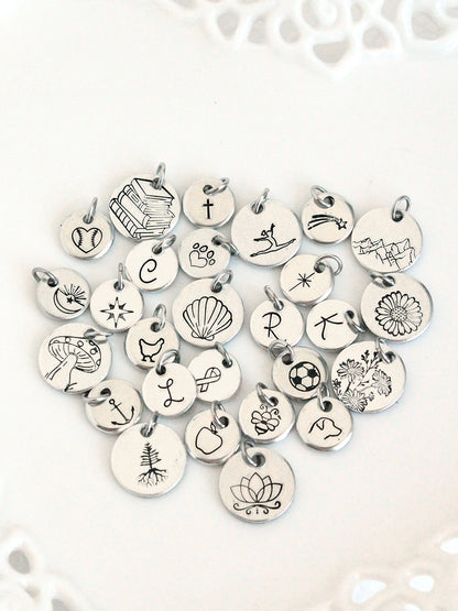Collection of various silver charms on a white background